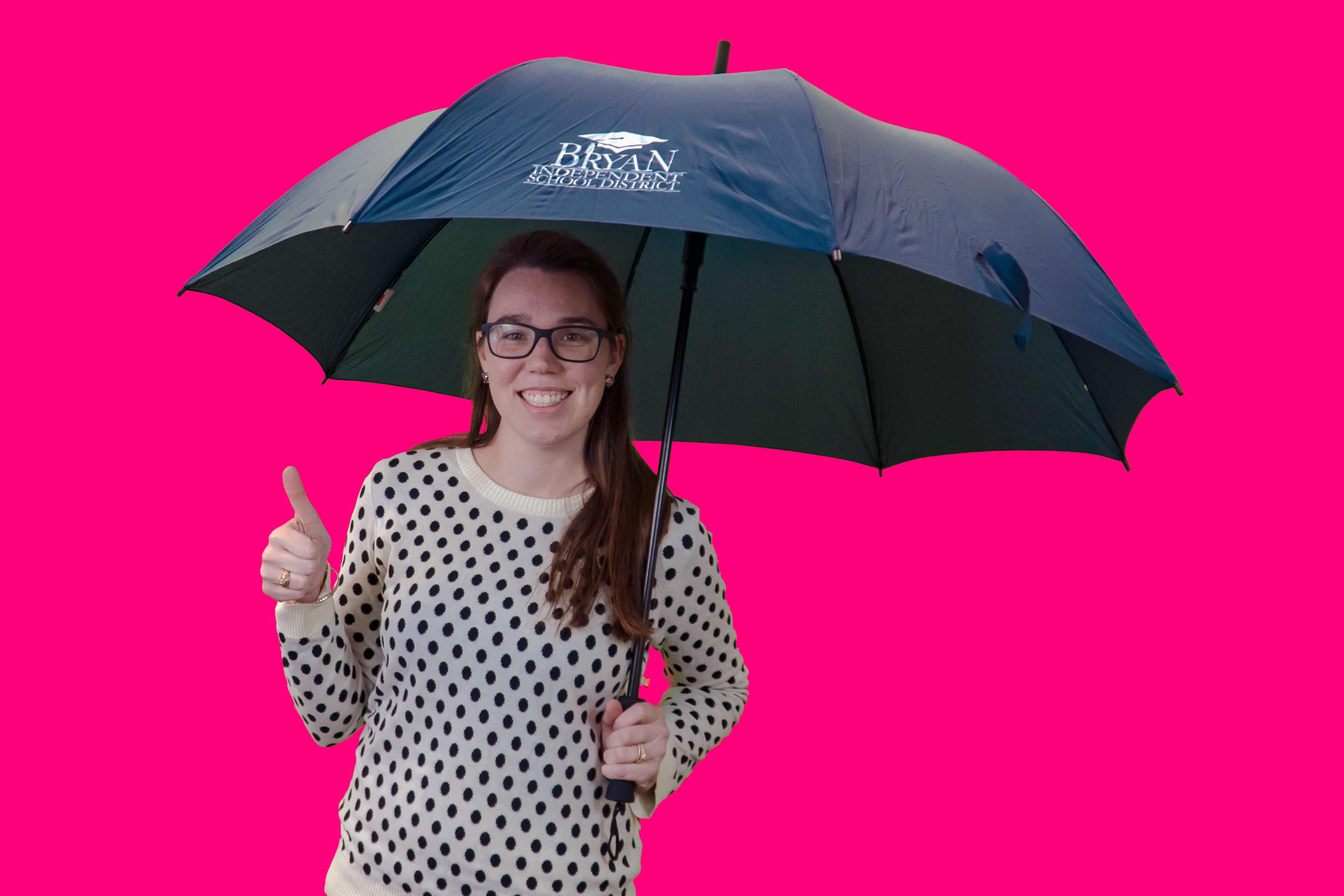 Bryan ISD prize winner giving a thumbs up sign while holding an umbrella