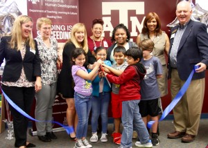 Bryan ISD students & employees & community members cutting the ribbon for Fannin's Reading clinic