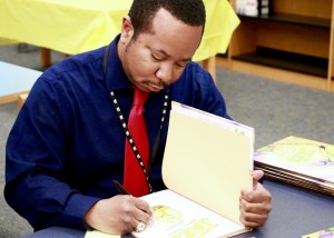 Samuel Pittman Signing a Copy of Alligator Jazz